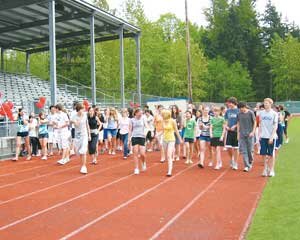 Liberty High School’s National Honor Society students at last year's walkathon start the first lap on the school track to raise money for library books for Liberty, and for student-life programs at a school and college in Mumbai, India. Contributed 