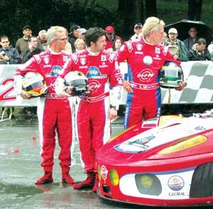 Team Seattle members (from left) Joe Foster, Patrick Dempsey and Newcastle’s Don Kitch Jr. watch as another team’s car goes through technical inspection leading up to last month’s 24 Hours of Le Mans. The team raised $250,000 for the Infant Cardiac Care Unit at Seattle’s Children’s Hospital. contributed
