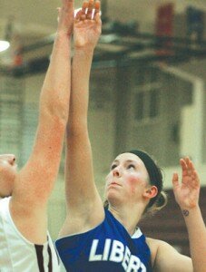By Greg Farrar Delane Agnew, Liberty High School junior forward, lofts two of her 14 points against Mercer Island over sophomore guard Ari Moscatel during the third quarter.