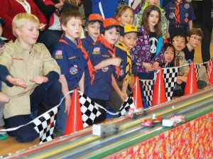 By Christina Corrales-ToyAudience members eagerly watch as derby cars race down the track at Newcastle Cub Scout Pack 738’s 2013 Pinewood Derby.