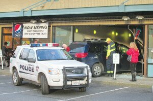 By John Jensen Newcastle Police respond to the scene of a crash at Zoëyogurt on Feb. 18. No one was injured when a minivan drove into the storefront.