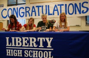 By Christina Corrales-ToyLiberty soccer players (from left) Nicolle Marlow, Kailiana Johnson, Katie Noonan and Kiana Hafferty sign their letters of intent to play collegiate soccer.