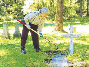 Contributed A volunteer helps spruce up the Newcastle Cemetery during a spring cleaning in 2010.