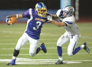 By Greg Farrar Marquise Lee (3), Hazen High School junior running back, works to elude Liberty defensive back Kasper Lui Delange on a play during the fourth quarter of their Sept. 13 football game at Renton Memorial Stadium.