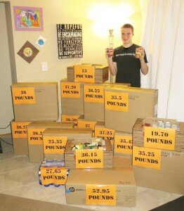 Contributed Sam Catherall, Maywood Middle School eighth-grader, stands among the 576 pounds of canned and nonperishable food he collected for his school’s annual food drive.