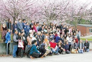 By Greg Farrar Japanese cultural exchange students and the Liberty High School families hosting them get together for a group photo, appropriately among Japanese cherry trees in bloom, at a welcoming ceremony March 22 in Redmond.