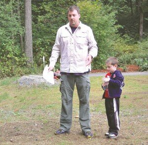 By Christina Corrales-Toy Mark Rigos, outgoing Newcastle Public Works director, with his son Alexander, speaks at the May Creek Trail ribbon-cutting ceremony Sept. 15.