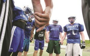 By Greg Farrar Liberty High School offensive players huddle to hear the call on the next play from scrimmage June 17 during the final spring practice for the Patriots.