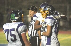 By Greg Farrar Justin Anderson (right), Hazen High School senior, is swarmed by teammates after scoring in the second quarter of the HighlandersÕ football game Sept. 12 against Liberty.