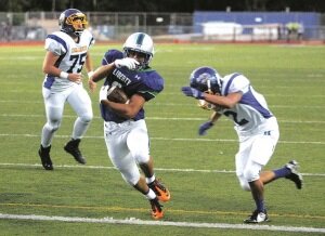 By Greg Farrar Preston Mitsui, Liberty High School junior wide receiver, carries the ball ten yards into the end zone, beating the tackle of Hazen junior defensive back Kevin Govea in the second quarter as the Patriots take a 21-0 lead Sept. 12.