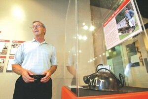By Greg Farrar Rich Crispo, Newcastle councilman, stands next to a display case with Milt Swanson's coal miner helmet and an information poster honoring the late 95-year-old Newcastle native's contributions to preserving the city's history. The Renton History Museum's Newcastle retrospective exhibit is on display until Feb. 7.
