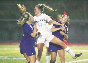 By Greg Farrar Jordan Hemmen (14), Liberty High School junior defender, watches her header score the first point for the Patriots in a 7-0 win Sept. 9 over Hazen High School.