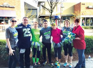 Contributed Newcastle Police Department officers Steve Kajihiro (second from left), Scott Yamamoto (fourth from left) and Chief Melinda Irvine (second from right) join their friends, including Sweet Decadence owner Sandra Wixon (far right), for a pre-race photo at the Seahawks’ 12K/5K run at The Landing in Renton on April 17.