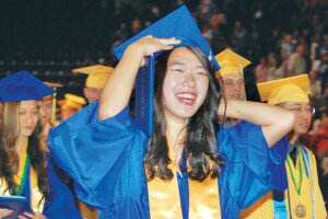 By Christina Corrales-Toy A 2014 Hazen High School graduate adjusts her cap at the Highlanders graduation ceremony last year. Both Liberty and Hazen students will receive their diplomas June 12.