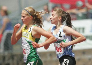 By Greg Farrar Carlyn Schmidgall (right), Liberty High School junior, races neck and neck in the final turn against Alexa Shindruk, of Lynden, in the 2A 3,200-meter championship May 30 in Tacoma. 