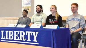 By Christina Corrales-Toy Liberty High School seniors (from left) Russell Boston, Nate Jarvis, Sarah Bliesner and Trevor Sytsma smile while listening to coaches talk about their high-school careers at a special Signing Day ceremony April 15 in the Liberty library.