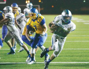 By Greg Farrar Joseph Cunningham (right), Liberty High School senior running back, slips past Hazen sophomore safety Jaeger Scheppe (7) to the end zone for a 3-yard touchdown run during the third quarter of their Sept. 11 football game.