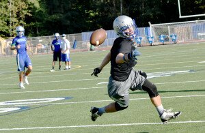 By Christina Corrales-Toy A Nate Solly pass slips through the fingers of Liberty High School senior running back Max Batali at an Aug. 21 football practice at Liberty High School.