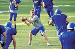 By Christina Corrales-Toy David Kilpatrick-White, Hazen High School’s head football coach, leads his team through warm-ups at an Aug. 26 preseason practice.