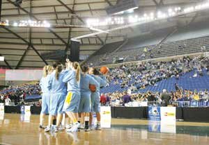 basketball-hhs-dome-2009031 The Hazen Highlanders girls basketball team rallies at center court as their first state tournament appearance in 18 years gets under way. By Greg Farrar