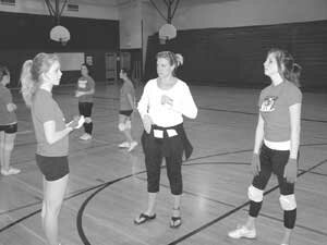 lhs-drill-team-20090224c Liberty High School drill coach Laura Gawler (center) goes over a routine with Kate Borgnes (left) and Haley Vincent. By Jim Feehan