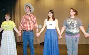 Sarah Hudson (left), Mason Catt, Laura Kooiman and Kayla Woodard perform a scene from Hazen High School’s production of Rodgers & Hammerstein’s ‘Oklahoma.’ By Jim Feehan