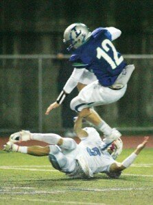 By Greg Farrar Jordan West, Liberty High School senior quarterback, leaps over a Juanita defender for a few more of his 26 yards on a third-quarter rushing play Oct. 21 against the Rebels.
