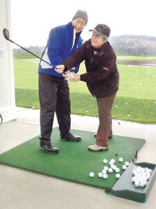 ContributedFormer professional golfer Peggy Conley (right) helps Dr. Phil Young perfect his golf swing during a lesson at The Golf Club at Newcastle.