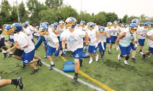 The Hazen High School varsity football team breaks from its rally huddle Aug. 22 at the end of afternoon practice.