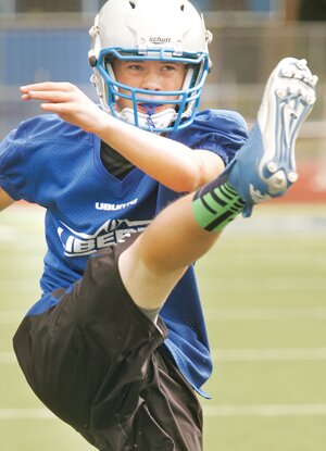 Greg Farrar Nate Solly, Liberty High School sophomore quarterback, kicks footballs Aug. 23 during a Patriot team practice.