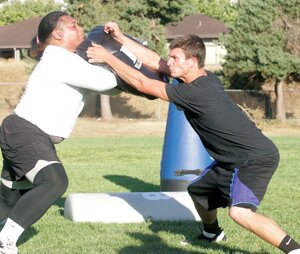 Greg Farrar Dalton Darlington (right), Liberty High School graduate and defensive lineman/linebacker, blocks an offensive lineman Aug. 6 during a Bellevue Bulldogs practice.