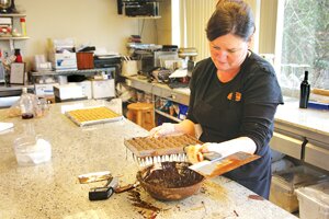 File Sandra Wixon, Sweet Decadence Chocolates owner, creates confections in the kitchen. Wixon and her popular chocolate store will relocate to The Landing in Renton in December.