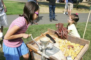 By Greg Farrar Children play with one of Mike Intlekofer's antique farming tools at the 2012 Newcastle Days celebration.