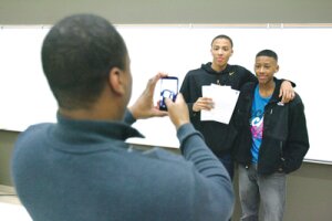 By Greg Farrar Dominic Green, Hazen High School senior, holds his signed letters of intent Nov. 12 and poses with his brother, Hazen freshman Jalen, for a photo taken by their dad, Jevon, on the Highlander campus.