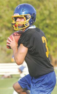 By Greg Farrar Nolan Hoover, Hazen High School senior quarterback, fades back and looks for a receiver Aug. 20 during the Highlanders’ first fall football practice of the 2014 campaign. Hoover will continue his football career at Pacific Lutheran University.